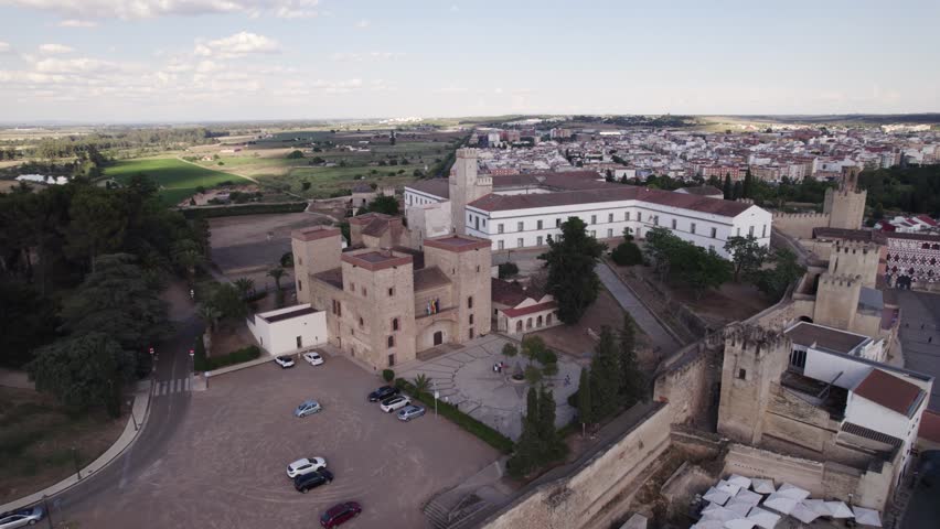Aerial pullback from Alcazaba fortress revealing Badajoz cityscape, Spain