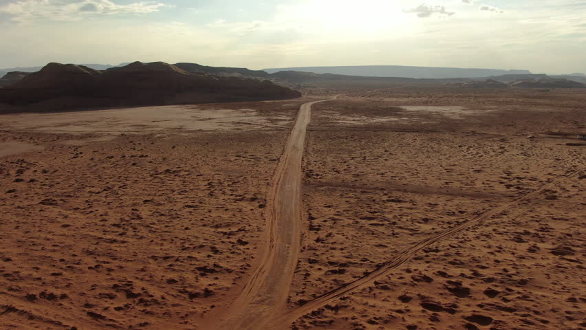 Monument Valley Sunset Dirt Road in Desert Aerial Shot Forward Navajo Nation Southwest Desert Arizona Utah USA