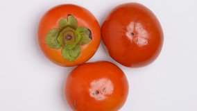 4K video of Japanese persimmon dolly shot against a white background.