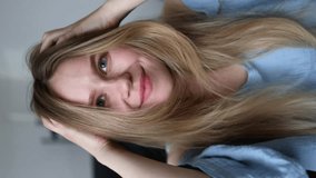 beautiful girl paints her eyebrows with mascara and straightens her hair. a woman applies makeup and looks at the camera. vertical video. getreadywithme grwm - Powered by Shutterstock - Get 15% off with code: PIKWIZARD15