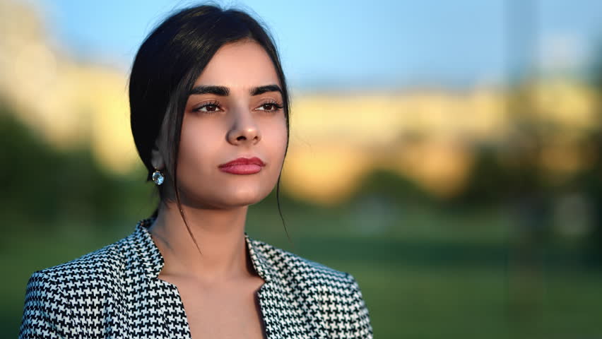 Fashion young business woman smiling dreaming relaxing breathing freedom city street outdoor closeup. Beautiful modern stylish female model spending time at urban sunny cityscape blurred background
