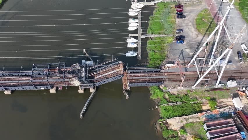 Aerial view of Railroad Draw Bridge closing over Cheesequake Creek in Morgan, NJ