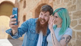 Man and woman couple smiling confident having video call at street