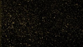 Gold dust particles fly in slow motion in the air lingering slowly. Dust Particles Background Bokeh Lights Background on Black Background 4k Footage Snow Particles Background. - Powered by Shutterstock - Get 15% off with code: PIKWIZARD15