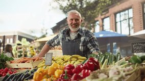 Portrait of a Man Managing a Street Vendor Food Stand with Fresh Natural Agricultural Products. Happy Old Handsome Farmer with Grey Hair and Beard is Looking at Camera and Charmingly Smiling - Powered by Shutterstock - Get 15% off with code: PIKWIZARD15