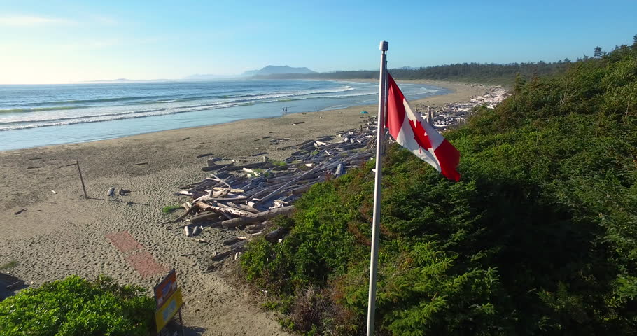 Flying Past Canada Flag Over Driftwood on a Vancouver Island Beach
