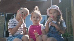 Three cute little Children enjoys delicious ice cream cone. Child eating watermelon popsicle. Kids Siblings snack sweets in Home Garden. Summer holiday Hot weather Sunny Day. Childhood, Food Candy - Powered by Shutterstock - Get 15% off with code: PIKWIZARD15
