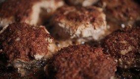 Fry the meatballs in oil on a pan with bubbles. Soft selective focus. Video clips.