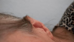 Carefully pre-empt the use of ear drops, Front shot of ear drop spillage for the health of the elderly person's ear
