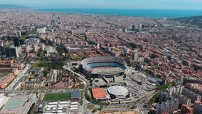 Aerial view of Barcelona Spotify Camp Nou and Barcelona city in Spain. Panoramic city landscape video ft the cosmopolitan capital of Spain’s Catalonia region, is known for its art and architecture 4K