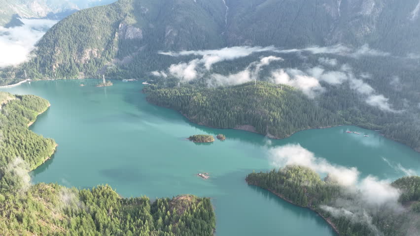 Clouds and forest-covered slopes surround Diablo Lake in North Cascades National Park. This mountainous region of northern Washington is absolutely beautiful and easily accessed during summer months.