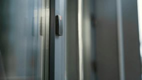 Close up of male hand unlocking door using mobile phone application. Unlocks a modern office building. Scanning open smartphone with mock up screen app. Smart electronic locks with keyless access - Powered by Shutterstock - Get 15% off with code: PIKWIZARD15