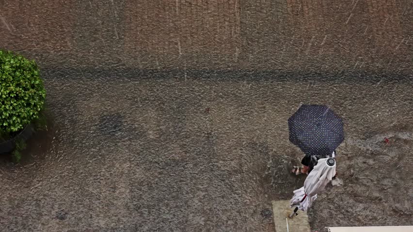 Urban Storm: Walking Under the Wet Umbrella