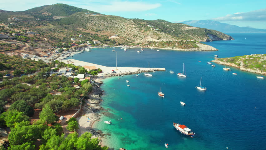 Agios Nikolaos fishing village and port on Zakynthos island, Ionian sea, Greece. Aerial view of boats in beautiful bay with turquoise water in small Greek Agios Nikolaos port in Zante. 