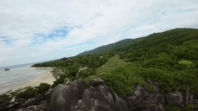 Filming on a Anse Source d'Argent beach in Seychelles on an Island Mahe, video of incredible trees, Seychelles rocks, seaside, and surrounding Seychelles landscapes.