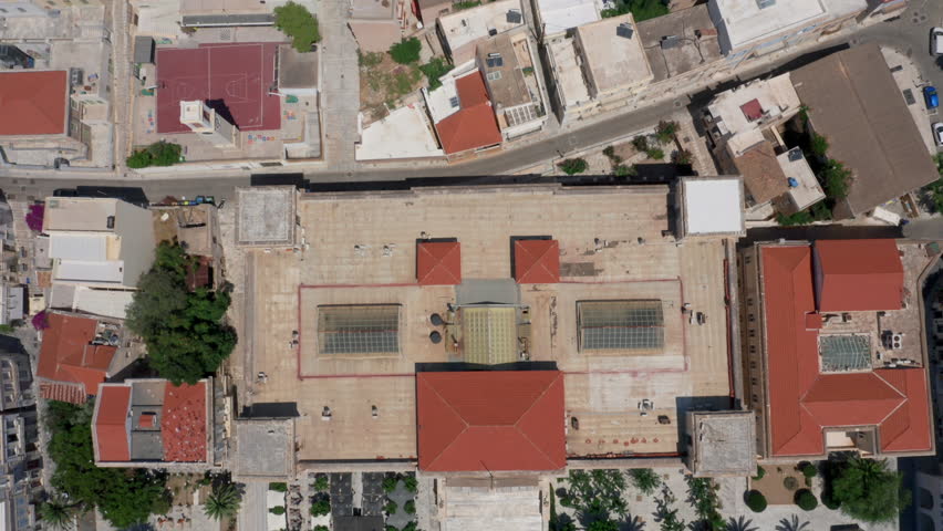 Aerial: Crane shot of Miaouli square and city hall building in Ermoupoli of Syros island, Greece during morning