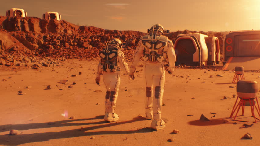 Two astronauts in spacesuits walk toward research station, colony or scientific base on Mars. AI powered rover rides in the background. Space mission. Futuristic colonization and exploration concept. Royalty-Free Stock Footage #1106865367