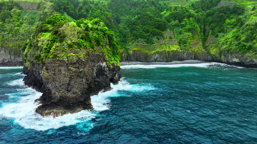 Scenic coast, Waves crash on the cliff shore, Untouched nature on sunny summer day, Cinematic wild nature aerial 4K, Slow motion waves of transparent turquoise sea waters, Madeira, Portugal