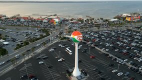 Aerial video orbit Pensacola Beach water tower and parking lot