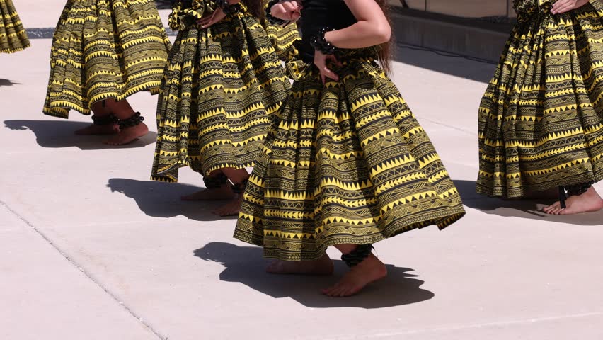 Young hula dancers wearing kukui nut anklets doing synchronized moves