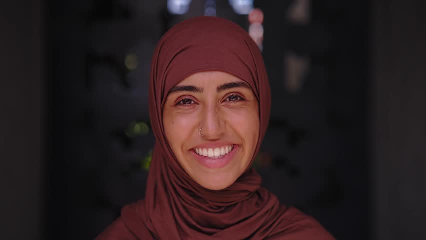 a beautiful woman in a forest, wearing hijab, looking_at camera, 