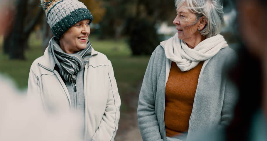 Caregiver, team and senior friends walking outdoor of a nursing home talking in a conversation for support and trust. Care, speaking and nurse exercise with elderly people for wellness and health Royalty-Free Stock Footage #1106870195