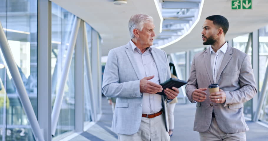 Tablet, talking or business people walking in office together for networking or communication in digital agency. Mature boss, coaching or employees enjoy speaking of an online plan in discussion