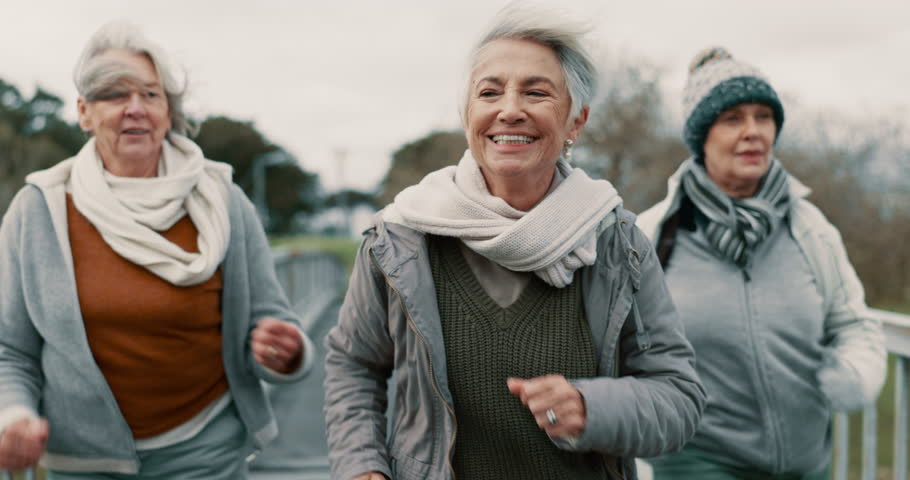 Senior women, fitness and group in park with smile, exercise and health on bridge in retirement. Elderly female friends, power walk and happy with training, workout and together for support in nature Royalty-Free Stock Footage #1106871395