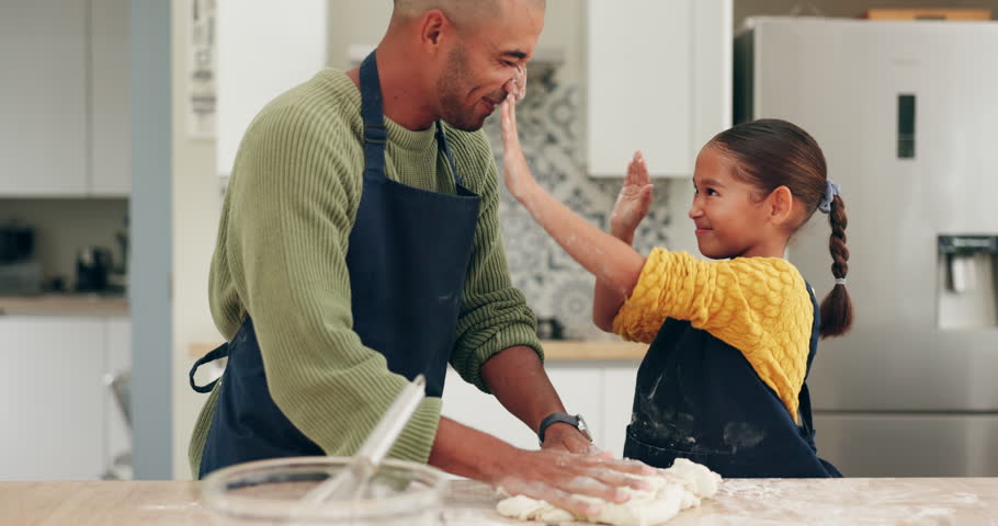 Messy, father and child baking with dough for playing, cooking or food for breakfast in a house. Happy, playful and a young dad with a girl kid in the kitchen and bonding with pastry or flour Royalty-Free Stock Footage #1106873955