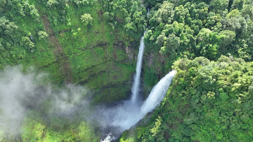 The Tad Fane waterfall, on the Bolaven Plateau in Laos, a few kilometers west of Paksong Town, in Champasak Province, within the Dong Houa Sao National Protected Area.bird eye view,aerial view Royalty-Free Stock Footage #1106875591