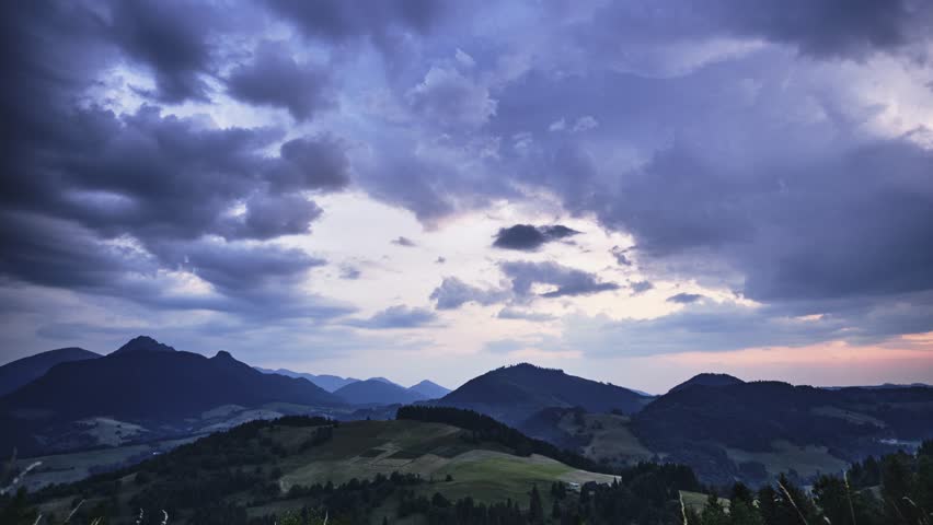 Dramatic clouds at dusk, bitter hilly rural landscape in the Carpathians