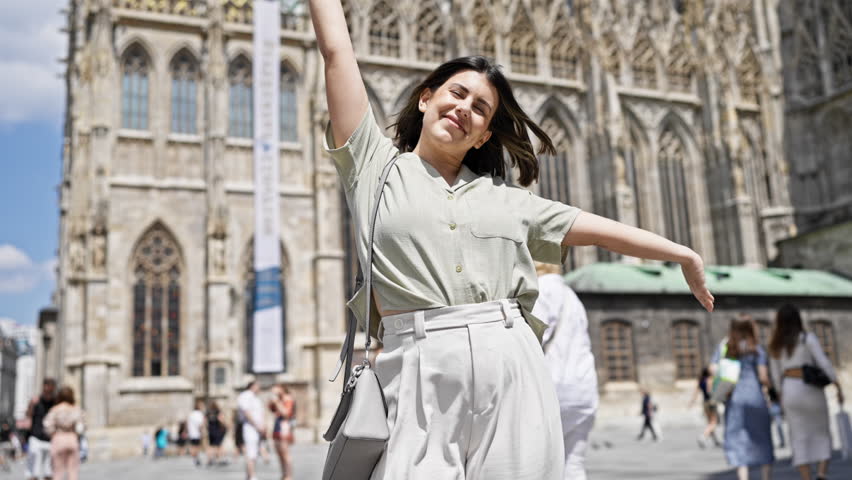 Young beautiful hispanic woman with open arms at St. Stephen