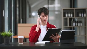 Successful Asian Businessman Analyzing Finance on Tablet and Laptop at modern Office Desk tax, report, accounting, statistics, and analytical research concept

