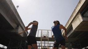 Two strong basketball player playing streetball match shooting and defense basketball on outdoor street court in sunny day. Healthy man athlete do sport training fitness workout exercise in the city. - Powered by Shutterstock - Get 15% off with code: PIKWIZARD15