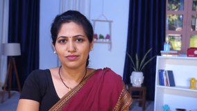 A middle-aged Indian lady is giving a toothy smile while looking towards the camera - posing, relaxation, wearing saree, Indian traditional dress . An Indian housewife in a traditional Saree in her... - Powered by Shutterstock - Get 15% off with code: PIKWIZARD15