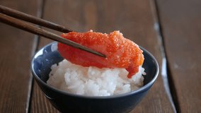 A video of mentaiko on freshly cooked rice. A dish of cod roe seasoned with chili pepper.