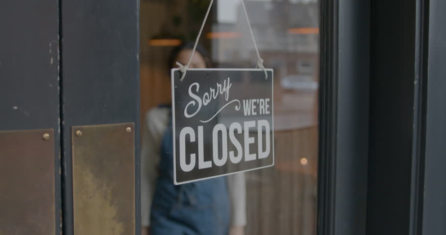 Employee Opening Cafe Restaurant, Turning Open Sign on Door