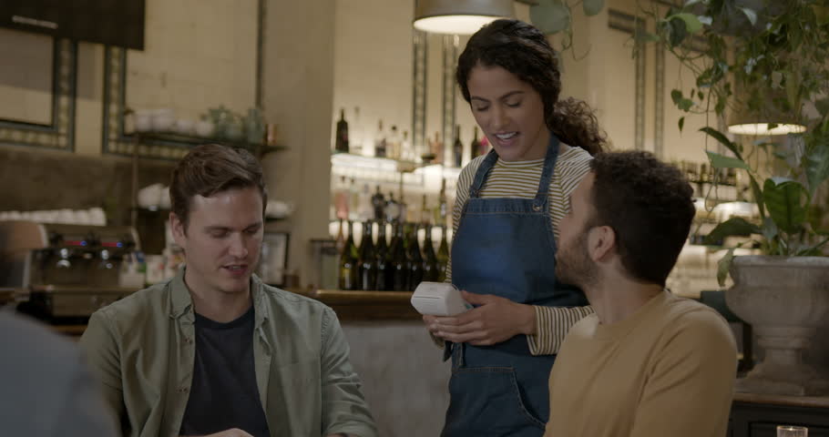 Male Paying for Dinner in Restaurant using Phone