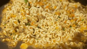 cooking instant noodle in a pot, add raw egg
