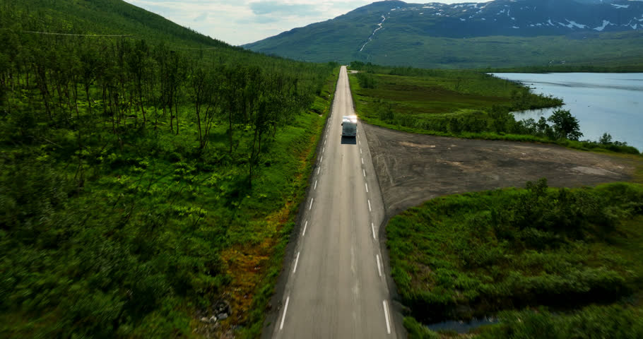 Drone shot tracking a campervan on a highland road, sunny day in Troms, Norway Royalty-Free Stock Footage #1106901275