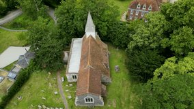 An angled push-in shot over All Saints church in West Stourmouth.