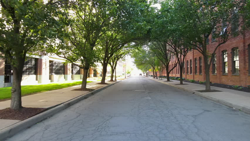 Traveling Under Trees Down An Empty Neighborhood Road In Michigan