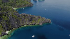Cinematic aerial footage tilt-up of the cliffs and bays of palawan with the ocean in bright blue at daylight, Palawan, Philippines, Asia, Drone