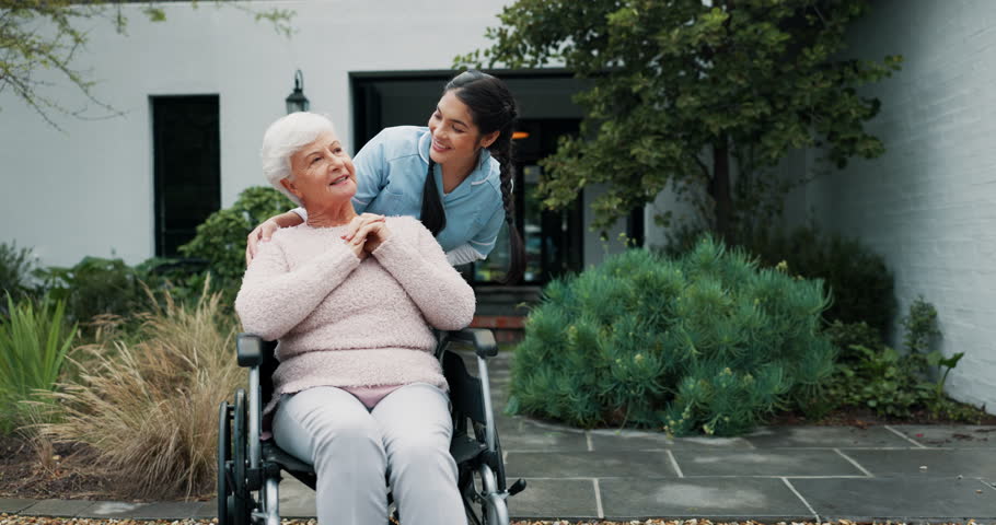 Happy nurse, wheelchair and elderly care in garden for outdoor walk in retirement or old age home. Female caregiver smile and talking to senior person with a disability in healthcare, support or help Royalty-Free Stock Footage #1106902479