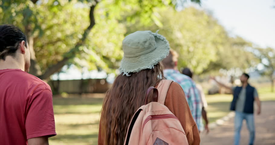 Back, walking and student friends on campus for a university tour of the college grounds together. School, education and orientation with a group of academic learners outdoor for higher learning Royalty-Free Stock Footage #1106902561