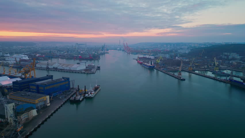 Aerial View of Flying Above the Gdynia Port. Logistics, Transportation, and Shipment Shot from Above. Huge Marine Port with Massive Towering Cranes and Ships