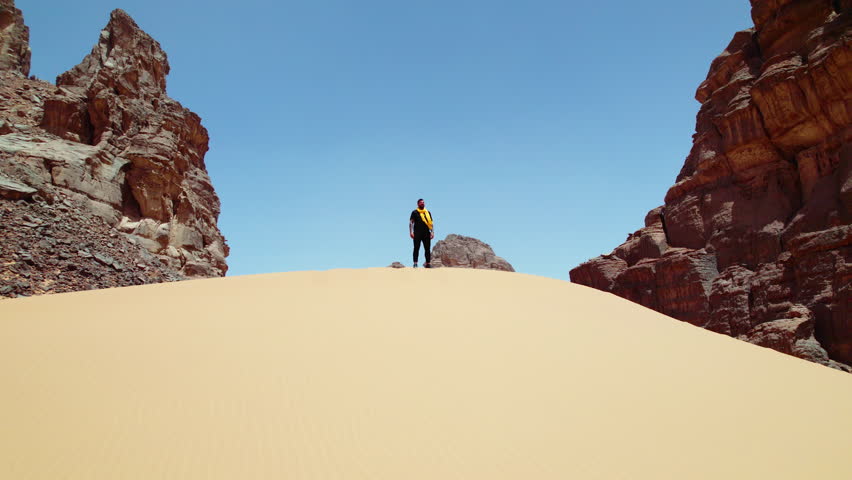 Man Standing On The Sand Dune In Djanet Desert, Algeria - aerial drone shot
