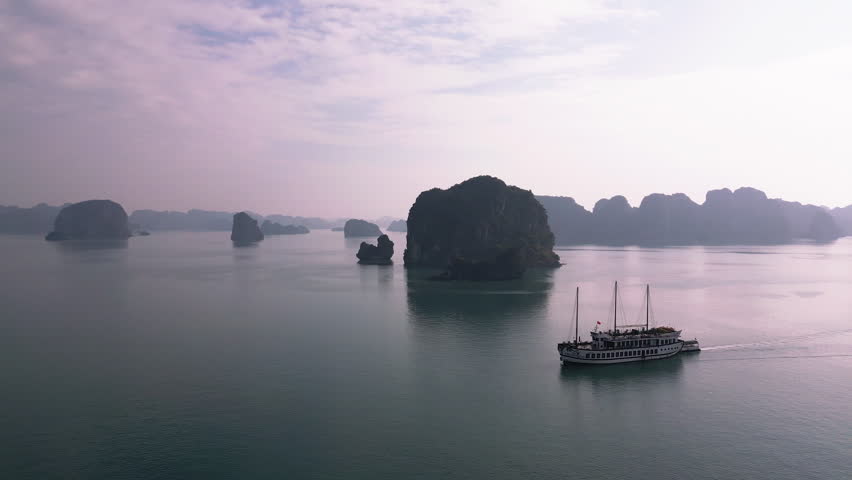 Aerial of Ha Long Bay rocks in blue azure sea. Travel destination in Vietnam Royalty-Free Stock Footage #1106909599