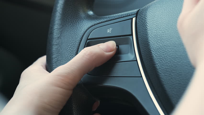 Car Driver Pressing Mute Button On Steering Wheel, Woman Switching Volume Button | Shutterstock HD Video #1106913095