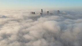 Aerial of the tall buildings of downtown Los Angeles poking through low clouds - Powered by Shutterstock - Get 15% off with code: PIKWIZARD15